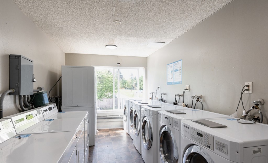 A row of washing machines in a laundromat.